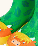 Frugi natural rubber, waterproof puddle buster wellingtons in palm/highland cow design showing water beading 