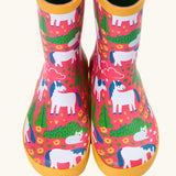 Front of Frugi puddle buster wellington boots showing the repeating cat and pony design on pink natural rubber material
