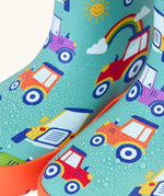 Frugi natural rubber, waterproof puddle buster wellingtons in terrific tractor design showing water beading 