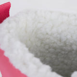 A close up of the Frugi out and about snow boots in rainbow check showing the white fleece inner detail