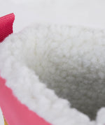 A close up of the Frugi out and about snow boots in rainbow check showing the white fleece inner detail