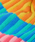 Frugi bobble hat showing close up of the rainbow stripe design on organic cotton fabric
