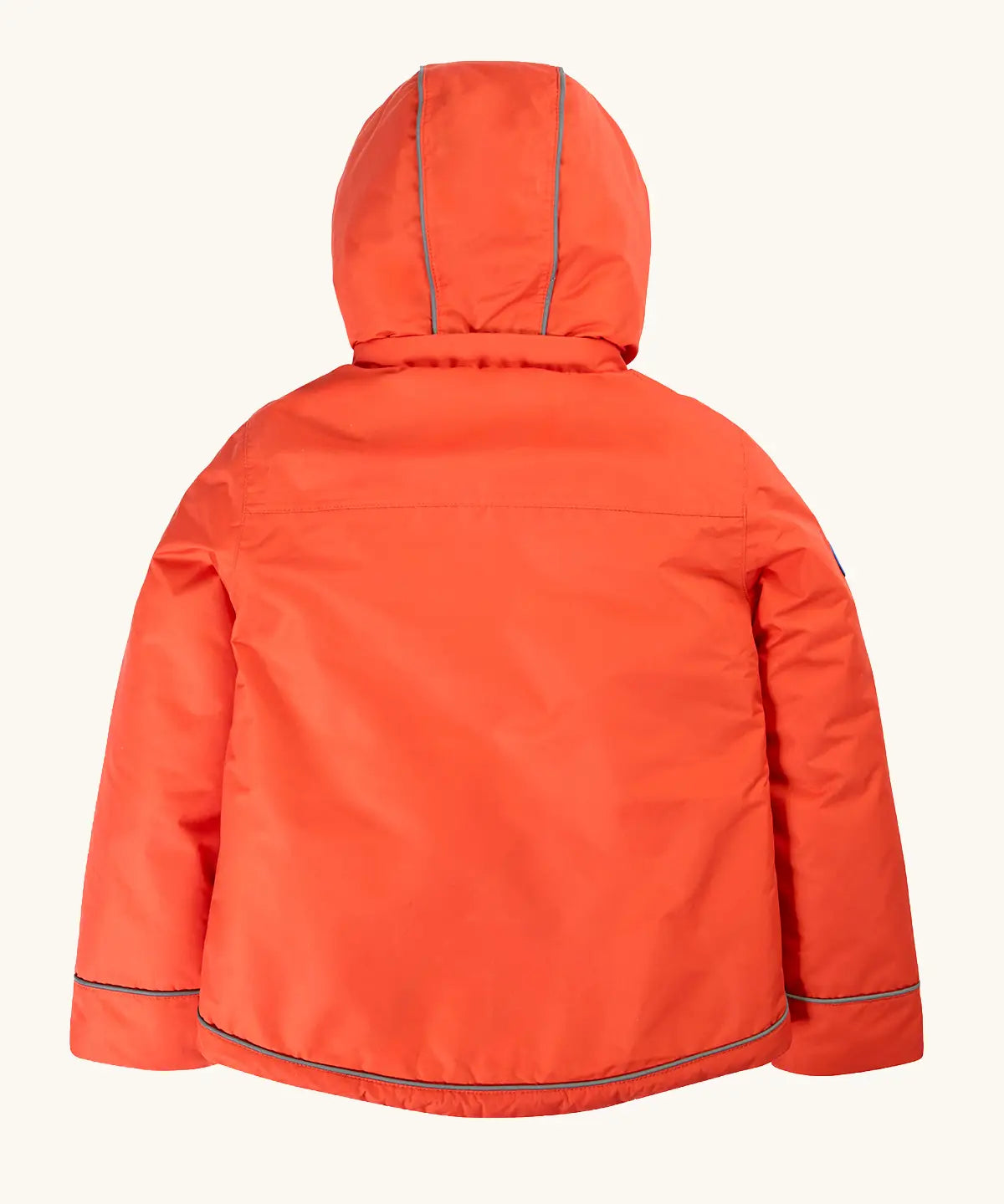 Back of the Frugi kids 3 in 1 rambler coat in fire upon a star. A orange waterproof coat with a thin reflective strip on the cuff hem and hood