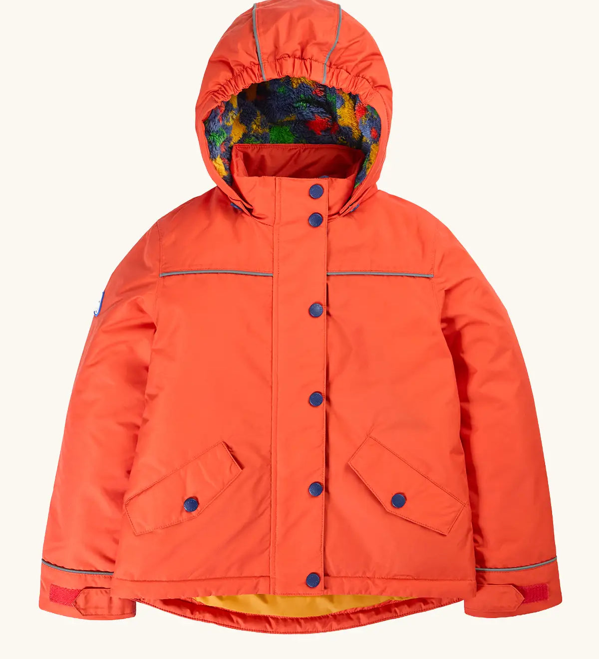 Frugi kids 3 in 1 rambler coat in fire upon a star. A orange waterproof coat Features a removable hood and 2 side pockets and a fleece inner
