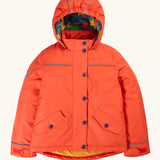 Frugi kids 3 in 1 rambler coat in fire upon a star. A orange waterproof coat Features a removable hood and 2 side pockets and a fleece inner