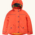 Frugi kids 3 in 1 rambler coat in fire upon a star. A orange waterproof coat Features a removable hood and 2 side pockets and a fleece inner