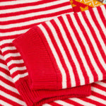 A closer look at the red and white stripe print on the sleeves of the Frugi Lumi Knitted Romper - Fairisle Christmas Stripe