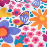 A close up of the retro floral design on the Frugi dragon skies Jamie jim jam bottoms available at Babipur. 