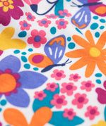 A close up of the retro floral design on the Frugi dragon skies Jamie jim jam bottoms available at Babipur. 