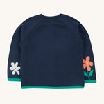 The back of the Frugi Reva Knitted Cardigan - Navy Blue/Cat, showing the flower design on the bottom of the sleeves