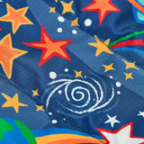 Frugi reversible toasty trail jacket in explore the stars showing a close up of the repeating outer space design on navy post consumer polyester material