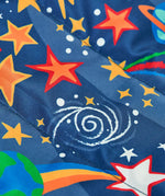 Frugi reversible toasty trail jacket in explore the stars showing a close up of the repeating outer space design on navy post consumer polyester material