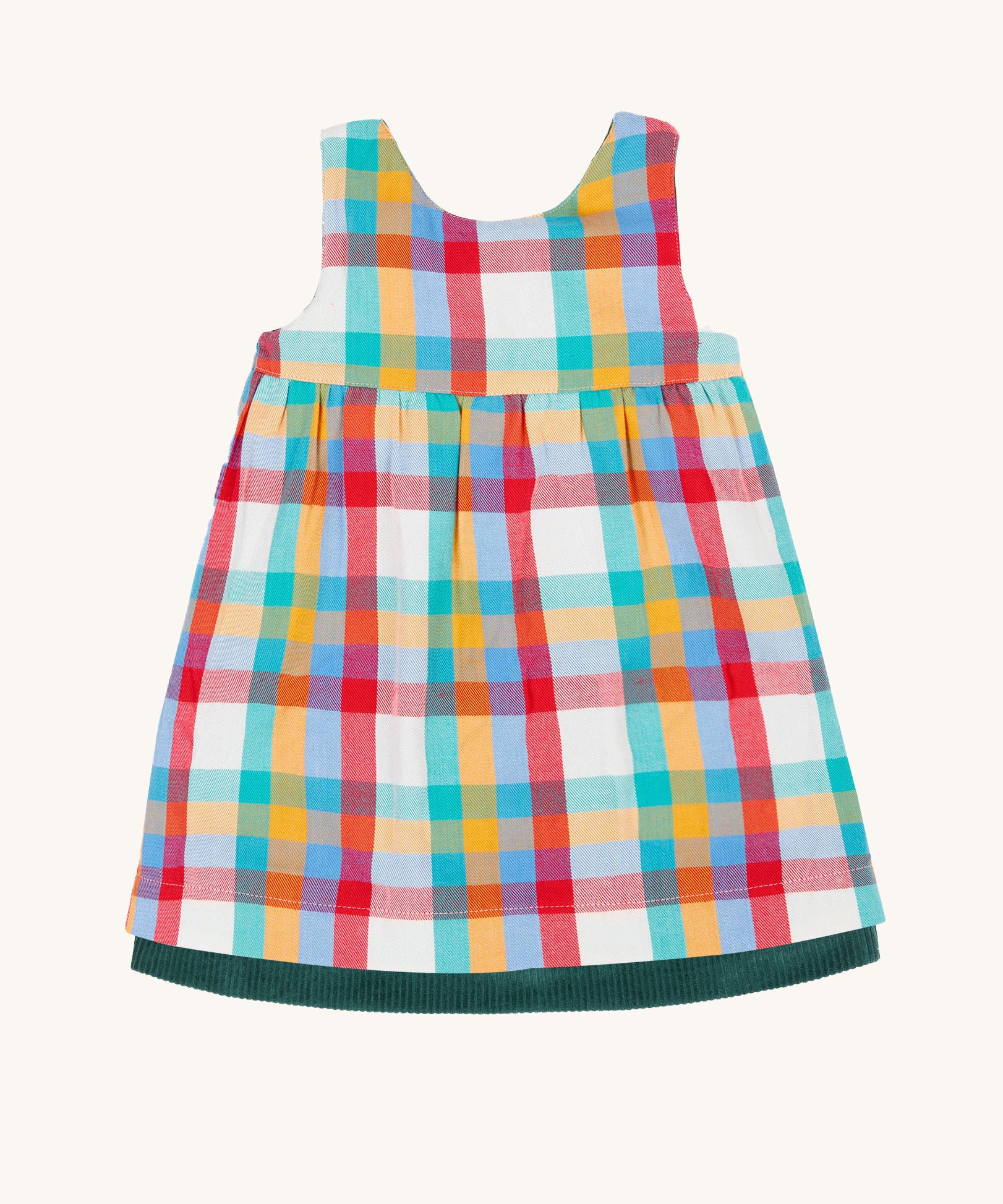 The rainbow check side of the Frugi Rosalie Reversible Baby and Toddler Dress. One side features robin readbreast appliques on a Holly green cord with the other side featuring a rainbow coloured check. This dress is a part of a wide range of organic cotton clothing for children available here at Babipur. 
