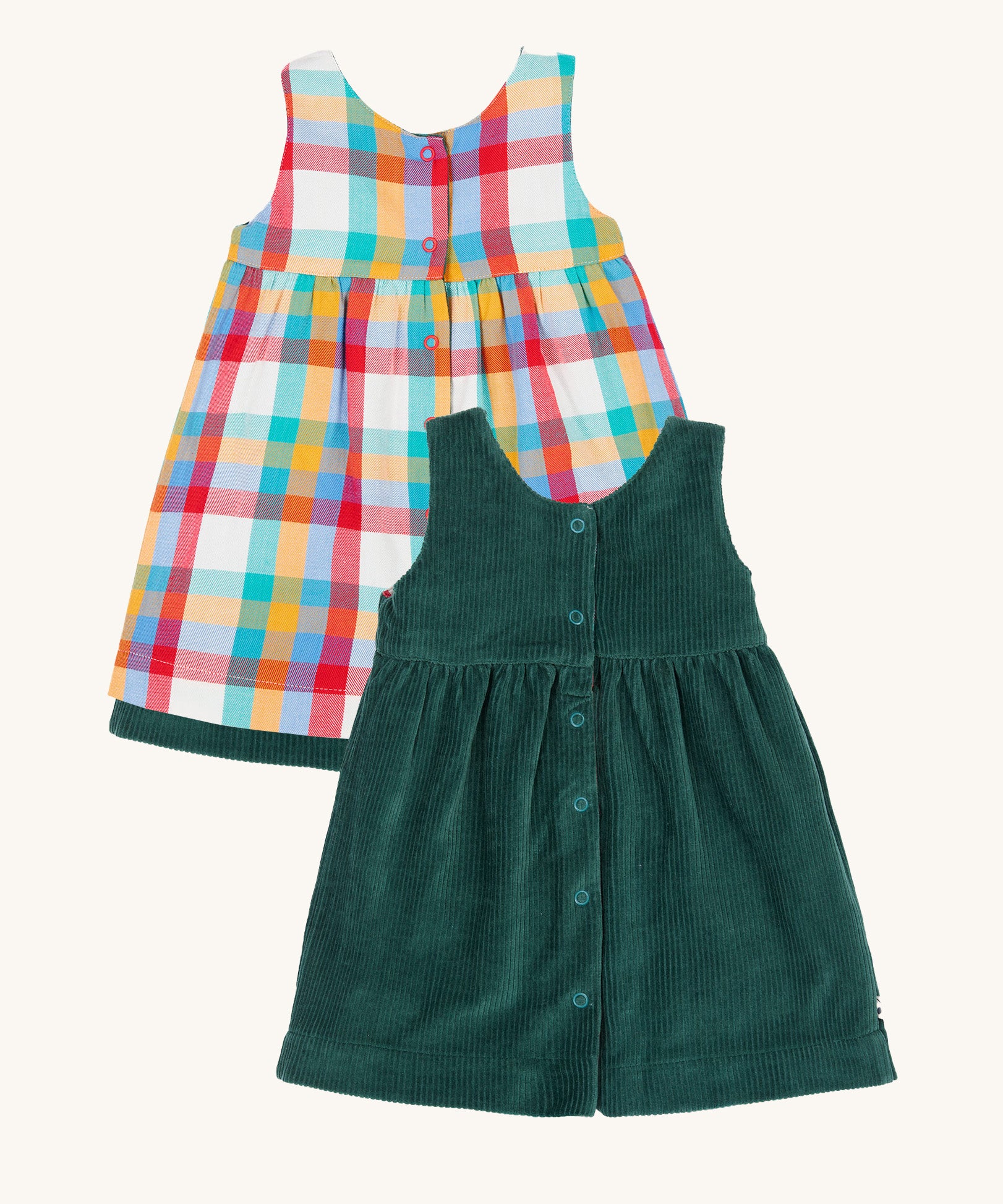The back of the Frugi Rosalie Reversible Baby and Toddler Dress. One side features robin readbreast appliques on a Holly green cord with the other side featuring a rainbow coloured check. This dress is a part of a wide range of organic cotton clothing for children available here at Babipur. 