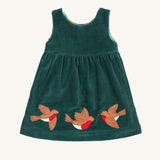 The holly green cord side of the Frugi Rosalie Reversible Baby and Toddler Dress. One side features robin readbreast appliques on a Holly green cord with the other side featuring a rainbow coloured check. This dress is a part of a wide range of organic cotton clothing for children available here at Babipur. 