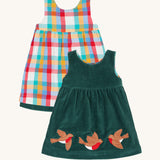 Frugi Rosalie Reversible Baby and Toddler Dress. One side features robin readbreast appliques on a Holly green cord with the other side featuring a rainbow coloured check. This dress is a part of a wide range of organic cotton clothing for children available here at Babipur. 
