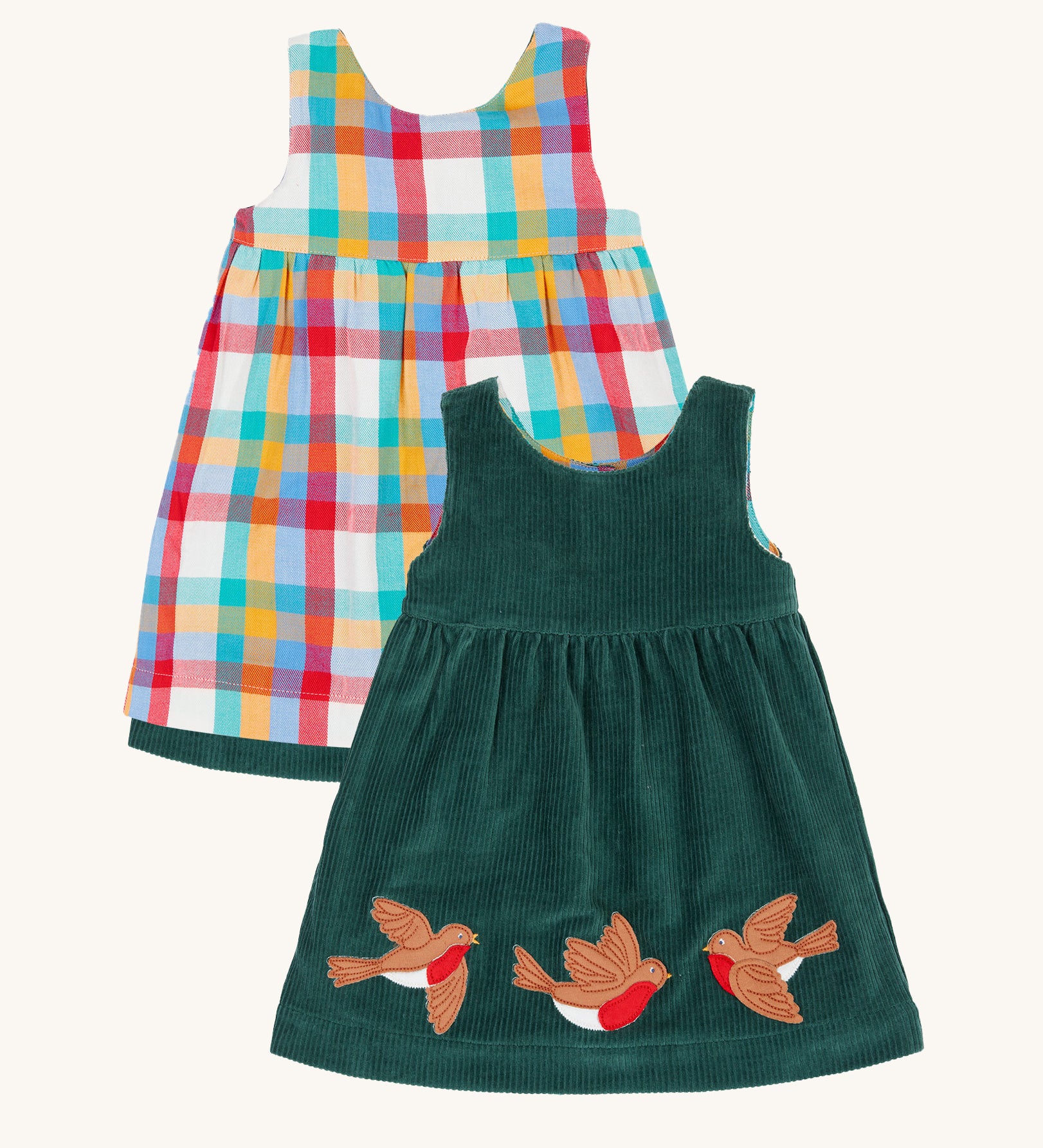 Frugi Rosalie Reversible Baby and Toddler Dress. One side features robin readbreast appliques on a Holly green cord with the other side featuring a rainbow coloured check. This dress is a part of a wide range of organic cotton clothing for children available here at Babipur. 
