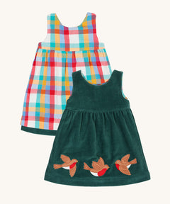 Frugi Rosalie Reversible Baby and Toddler Dress. One side features robin readbreast appliques on a Holly green cord with the other side featuring a rainbow coloured check. This dress is a part of a wide range of organic cotton clothing for children available here at Babipur. 
