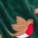 A close up of the robin appliques on the Frugi Rosalie Reversible Baby and Toddler Dress. One side features robin readbreast appliques on a Holly green cord with the other side featuring a rainbow coloured check. This dress is a part of a wide range of organic cotton clothing for children available here at Babipur. 
