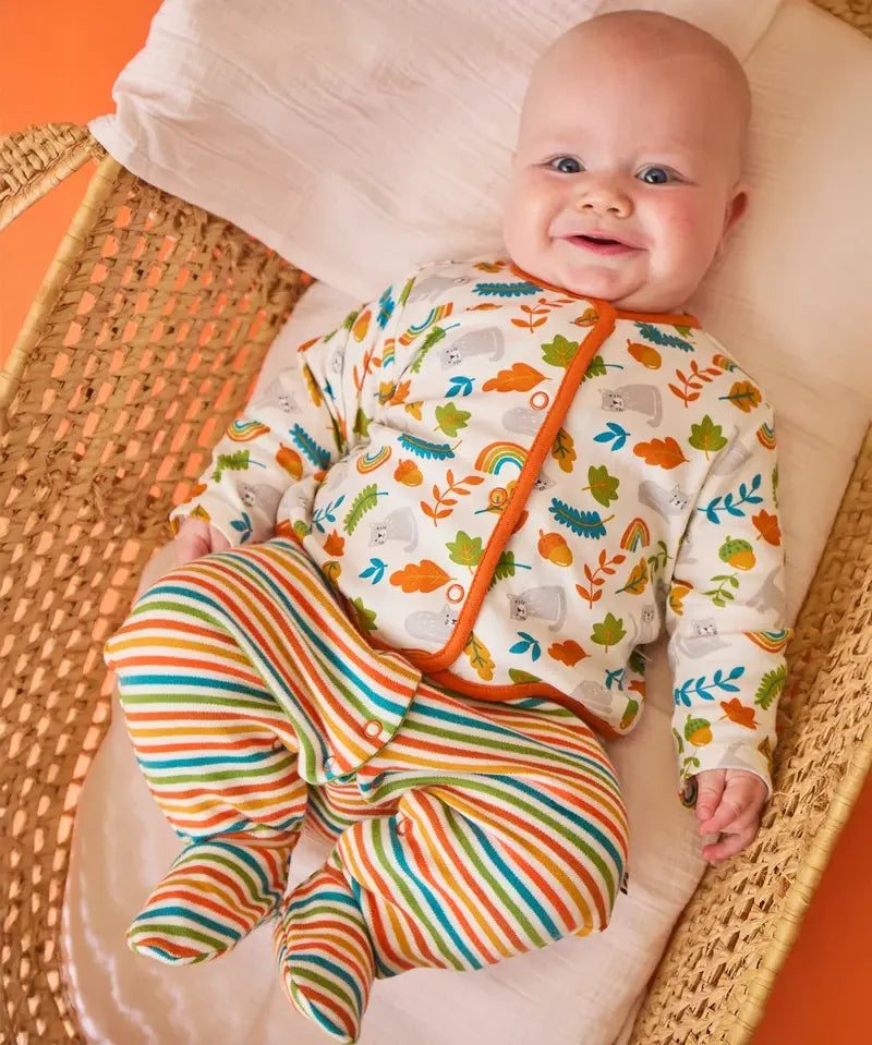 Frugi Scrumptious baby gift set worn by baby - striped orange and green babygrow with wild cat print cotton cardigan.