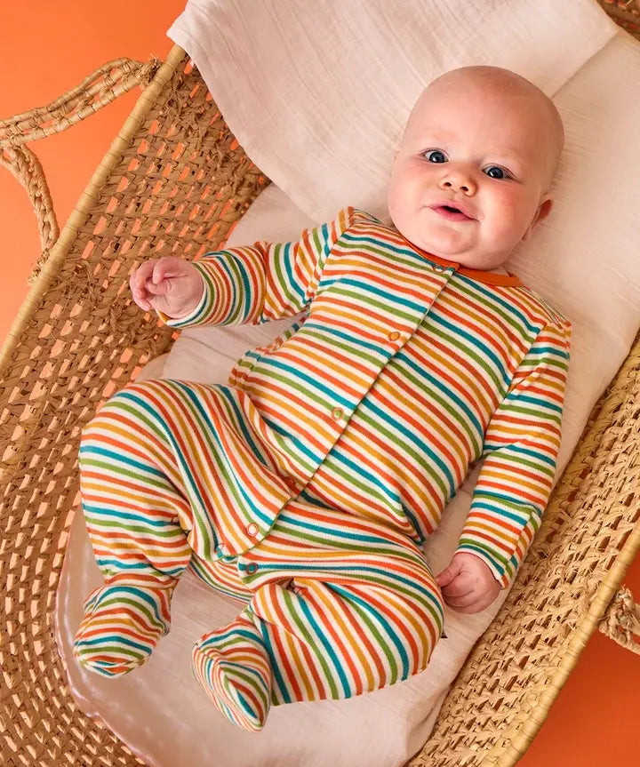 Frugi striped orange organic cotton babygrow from scrumptious gift set, worn by baby.
