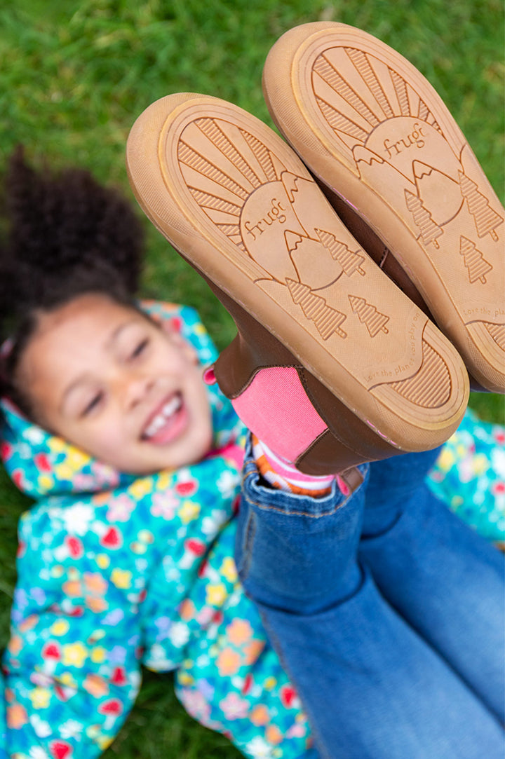 Child's feet in the air showing the flexible and roomy fit soles of the Frugi Ravine Easy On Brown Leather Boots with Wild Woods lining - to represent Frugi Shoes at Babipur.