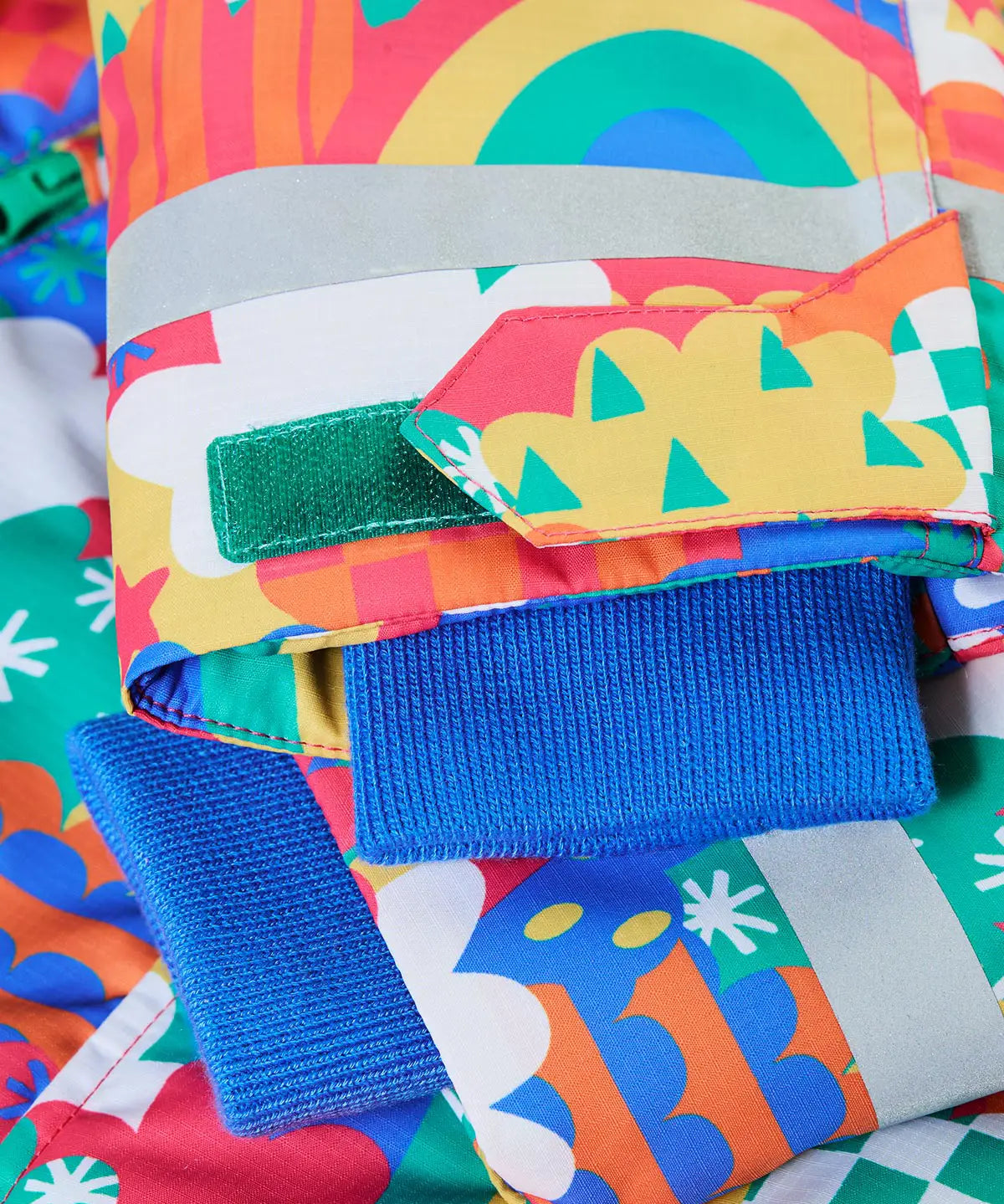 Frugi snow and ski coat in the fun frenzy design showing close up of adjustable velcro strap on the cuff