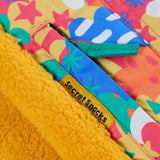Frugi snow and ski coat in the fun frenzy design showing a secret inside pocket 