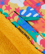 Frugi snow and ski coat in the fun frenzy design showing a secret inside pocket 