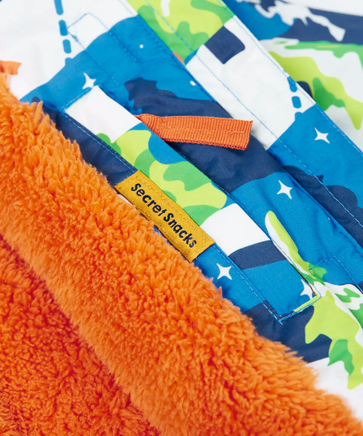 Frugi snow and ski coat in the starry slopes design showing a secret inside pocket 