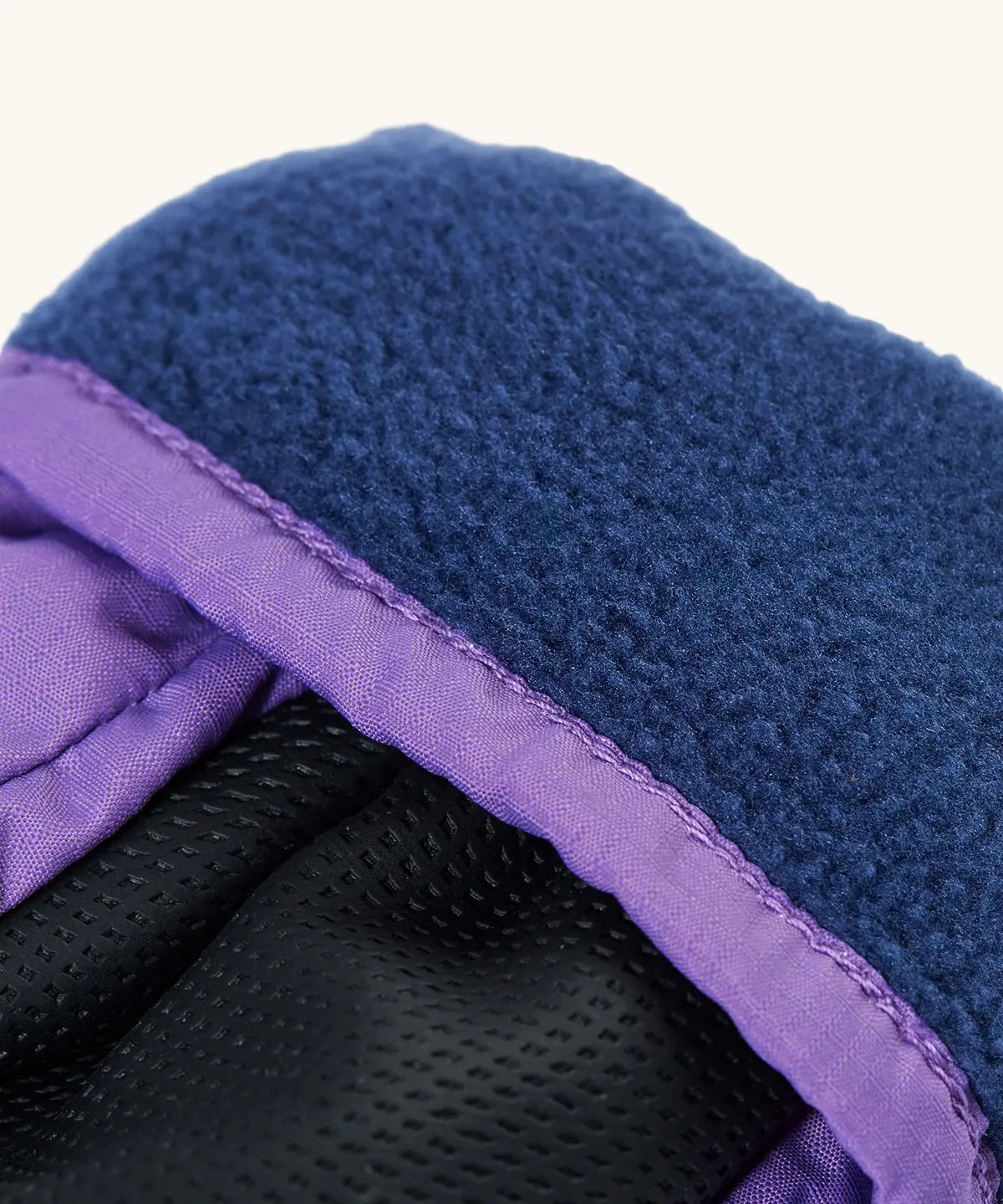 Frugi kids fig/snow scene snow mittens. Showing close up of navy fleece inner
