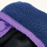 Frugi kids fig/snow scene snow mittens. Showing close up of navy fleece inner