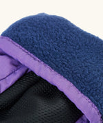 Frugi kids fig/snow scene snow mittens. Showing close up of navy fleece inner