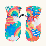 Frugi kids fun frenzy snow mittens. A pair of recycled polyester winter mittens  with a rainbow and repeating bright pattern design. features a black clip on each mitten 