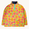 Frugi organic cotton fleece laid flat. In yellow with a navy fleece inner and a repeating floral print