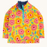 Frugi organic cotton fleece laid flat. In yellow with a navy fleece inner and a repeating floral print with a 1/4 length popper fastener