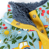 Close up of the light blue Frugi fleece showing the dark blue fleece inner and repeating farm themed print