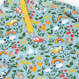 A close up of the light blue Frugi organic cotton fleece laid flat showing the repeating farm themed print and pouch pocket.