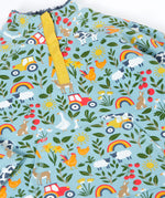 A close up of the light blue Frugi organic cotton fleece laid flat showing the repeating farm themed print and pouch pocket.