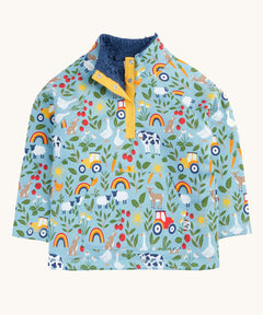 Frugi organic cotton fleece laid flat. In light blue with a repeating farm themes print. Features a dark blue fleece inner and popper fasteners 