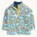 Frugi organic cotton fleece laid flat. In light blue with a repeating farm themes print. Features a dark blue fleece inner and popper fasteners 