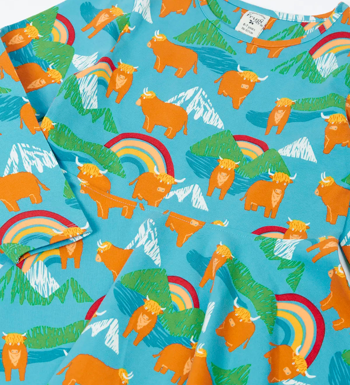 Frugi GOTS 100% organic cotton long sleeve skater dress with repeating highland cows and mountain prints laid flat 