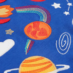A closer look at the yellow, and orange applique planets, which also has space style embroidery details on a blue fabric