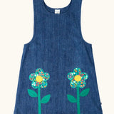 Frugi GOTS organic cotton mid wash denim kids pinafore dress with 2 flower appliques on the gather