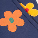 A closer look at the flower applique on the Frugi Perrin Parsnip Jogger - Navy Blue/Flowers