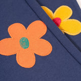 A closer look at the flower applique on the Frugi Perrin Parsnip Jogger - Navy Blue/Flowers