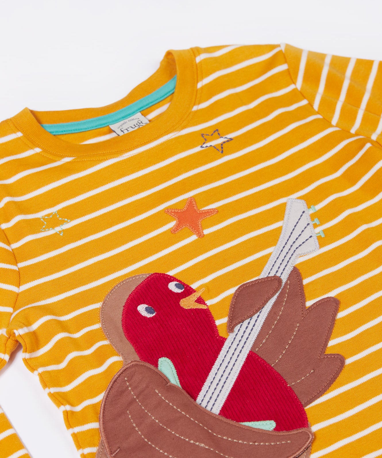 A close up of the Frugi Gold Rockin' Robin Summit Circular Organic Cotton Top available at Babipur showing the robin and star applique 
