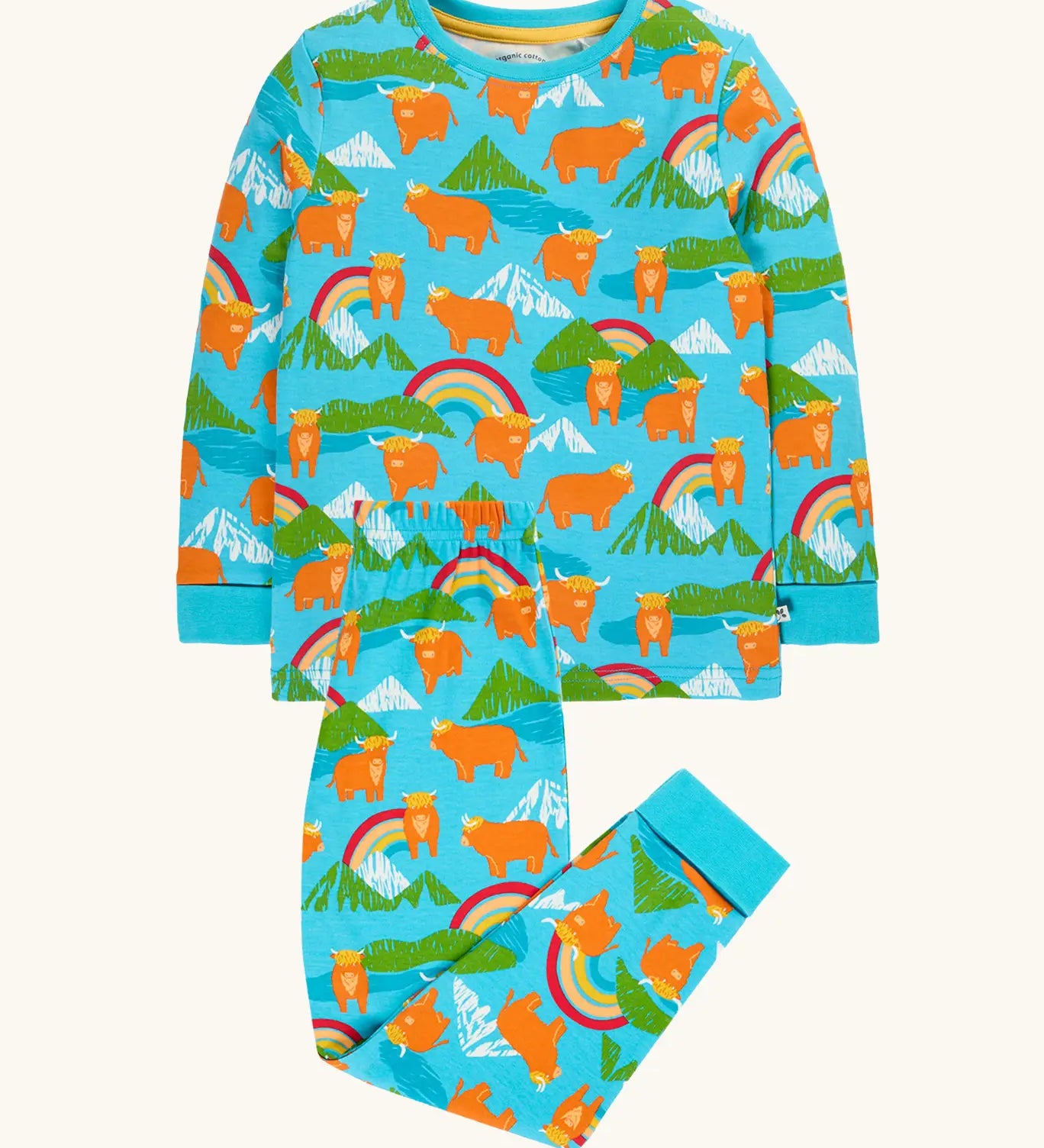 Frugi GOTS 100% organic cotton kids pyjamas including a light blue top with a repeating highland cow and mountain print and matching bottoms