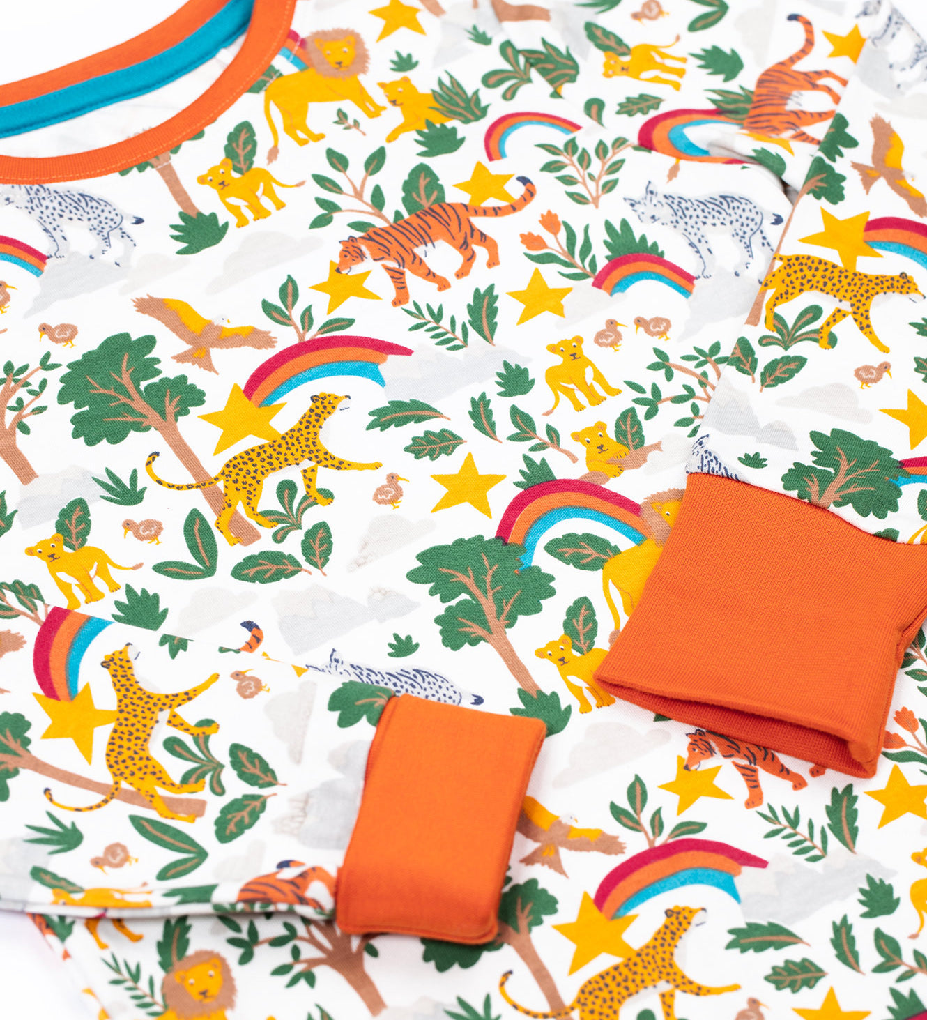 A close up of the Frugi sundown pyjamas top in into the wilds design available at Babipur showing the wildlife safari print and orange trim detail on the neck