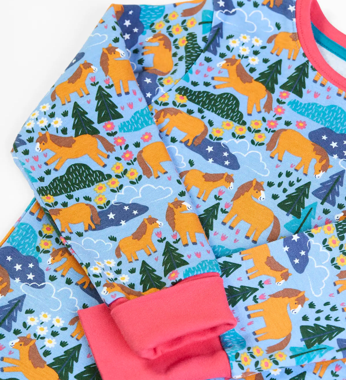 Frugi GOTS 100% organic cotton kids pyjama top in light blue with a repeating shetland pony print and a pink cuff and neck line 